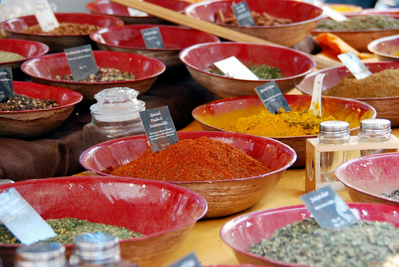 Bowls of colourful ground spices at a spice market